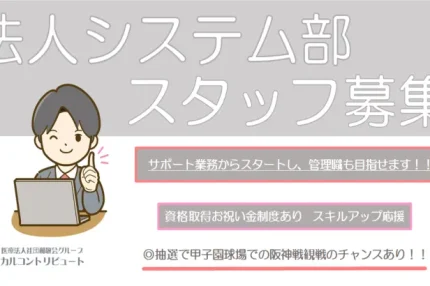 パソコンの前に座って人指す指を立てる男性